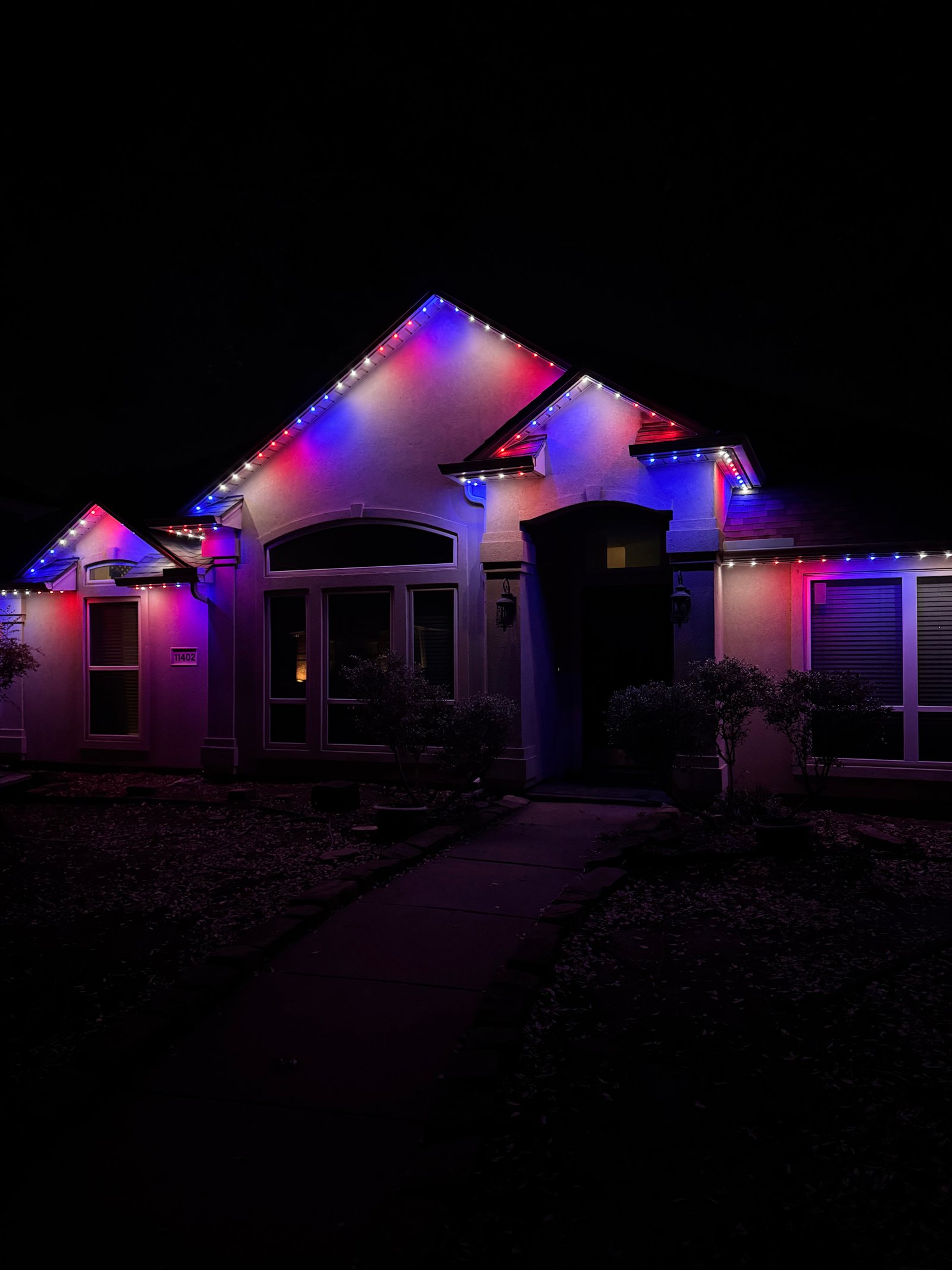 Two-story McKinney Texas home exterior showing invisible LED soffit lights during daytime