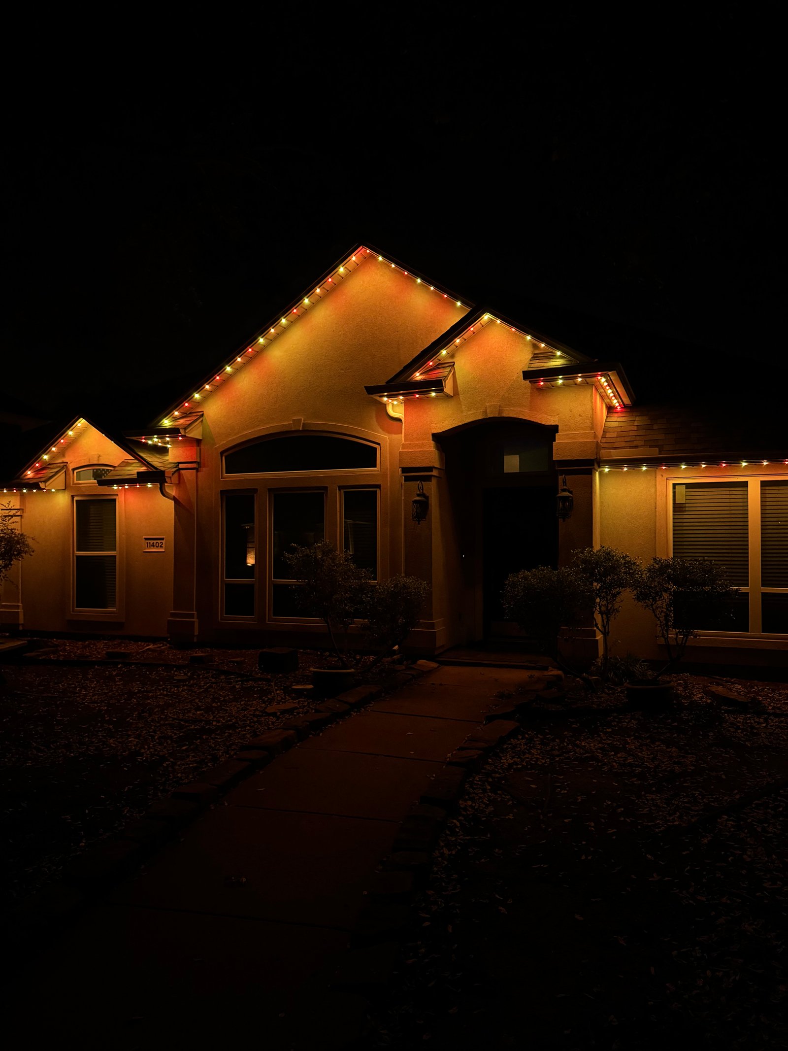 Allen Texas luxury home with warm orange and amber permanent LED lighting for fall