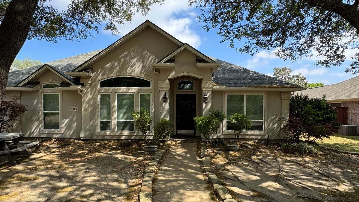 Home exterior during daytime before Celebright LED soffit lighting installation — plain roofline with no architectural lighting